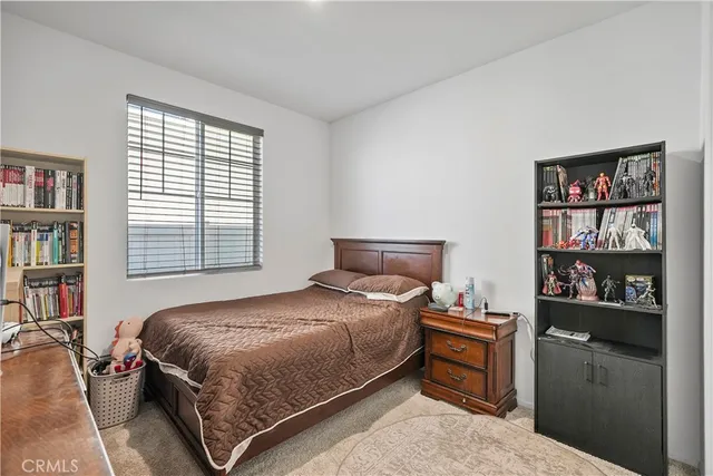 a bedroom with a bed cabinets and window