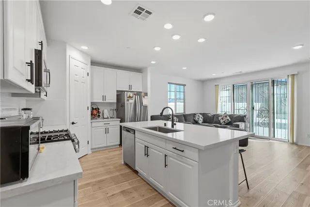 a kitchen with a sink stove and refrigerator