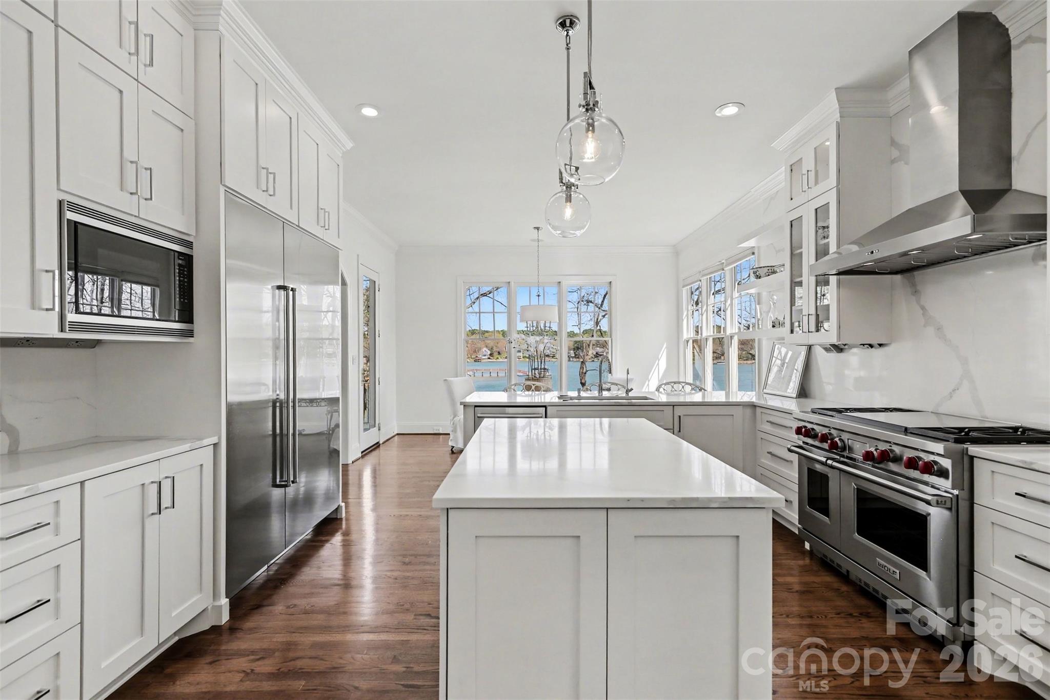 183 Mayfair Road Mooresville, NC 28117 - Photo 16 of 47 a kitchen with stainless steel appliances a stove a sink dishwasher a refrigerator and white cabinets with wooden floor