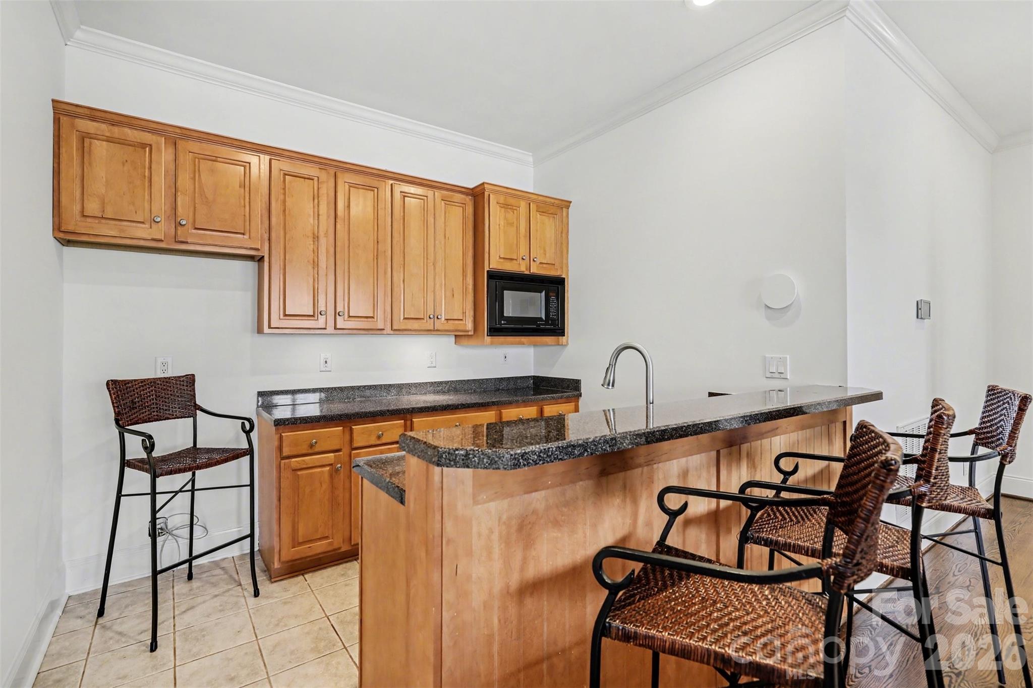 183 Mayfair Road Mooresville, NC 28117 - Photo 36 of 47 a kitchen with stainless steel appliances a table and chairs in it