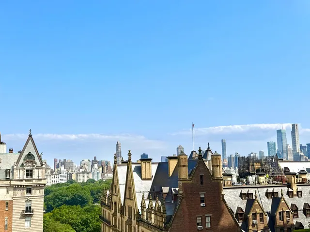 a bedroom with a bed table flowerpot and window