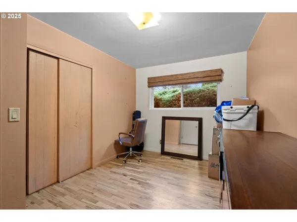 a room with a dresser and wooden floor