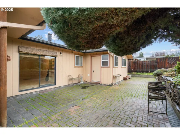a living room with a table and chair with wooden floor