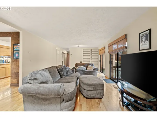 a living room with furniture and a wooden floor