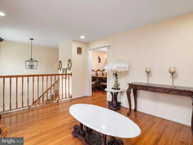 a living room with furniture a window and wooden floor