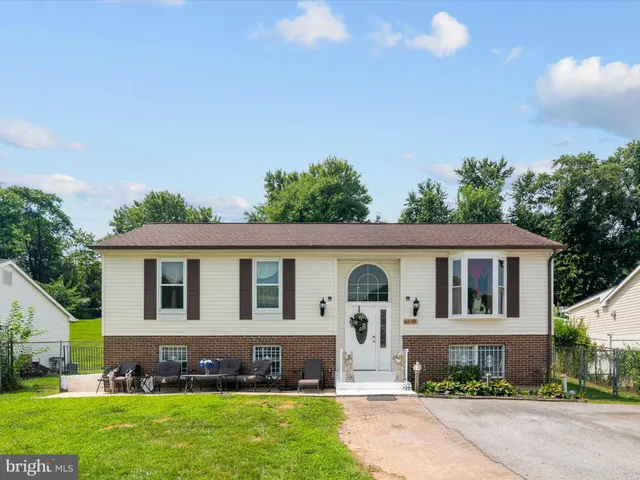 a front view of a house with a garden and yard