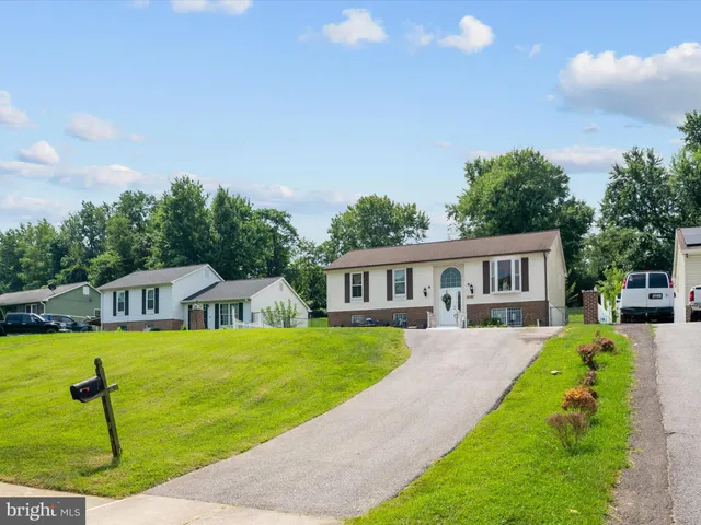 a view of a house with a yard patio and swimming pool