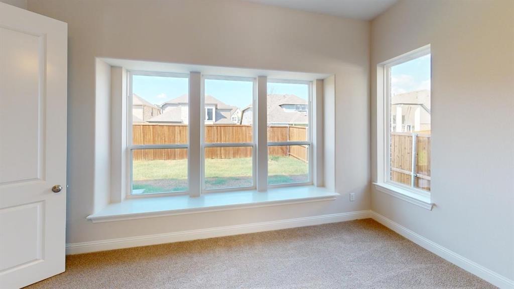 8407 Cornerstone Drive Rowlett, TX 75088 - Photo 17 of 25 Room featuring a large bay window with a built-in window seat, an additional vertical window, light beige wall paint, and neutral-toned carpeting