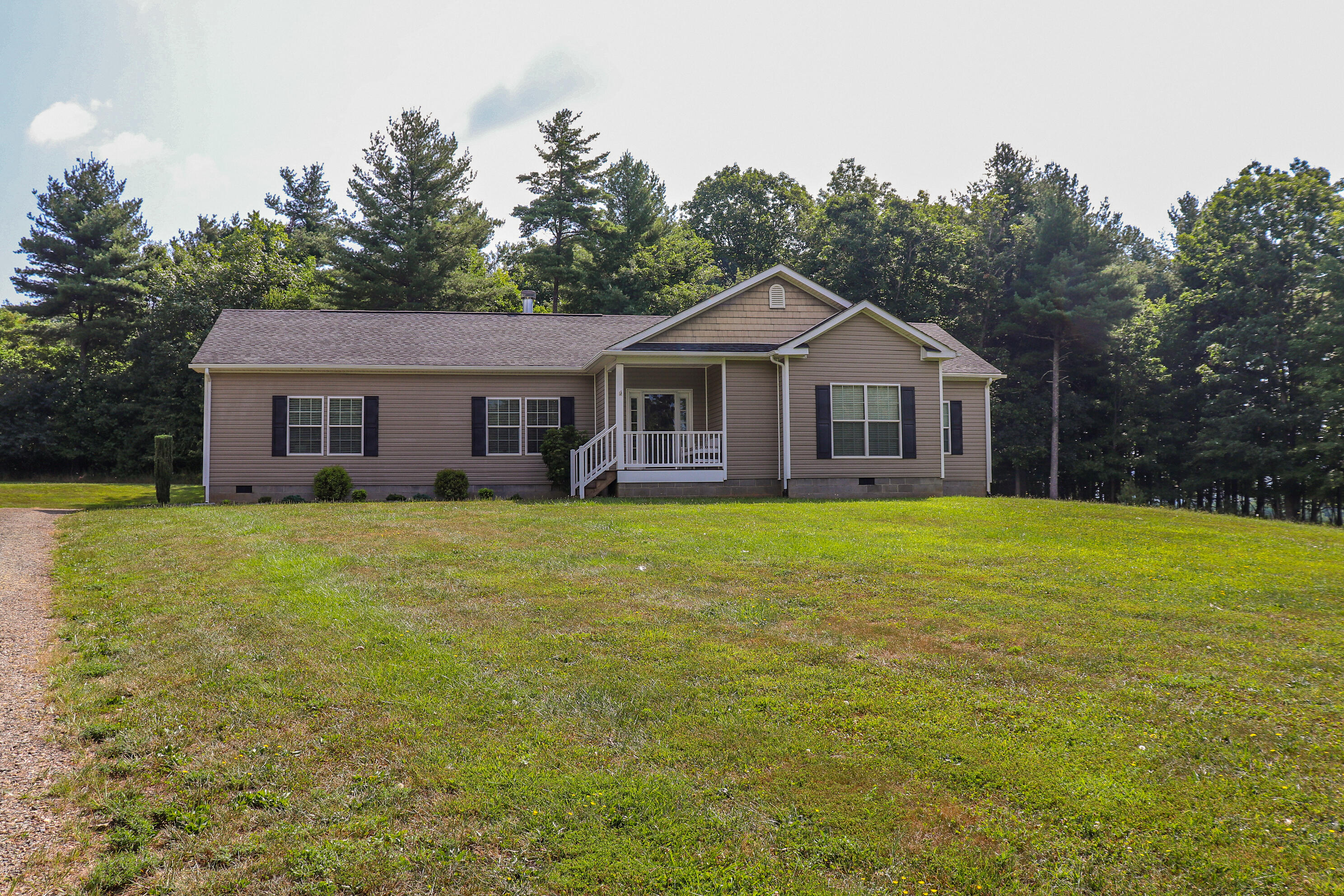 241 Sams Road Southeast Floyd, VA 24091 - Photo 2 of 28 a front view of a house with a garden