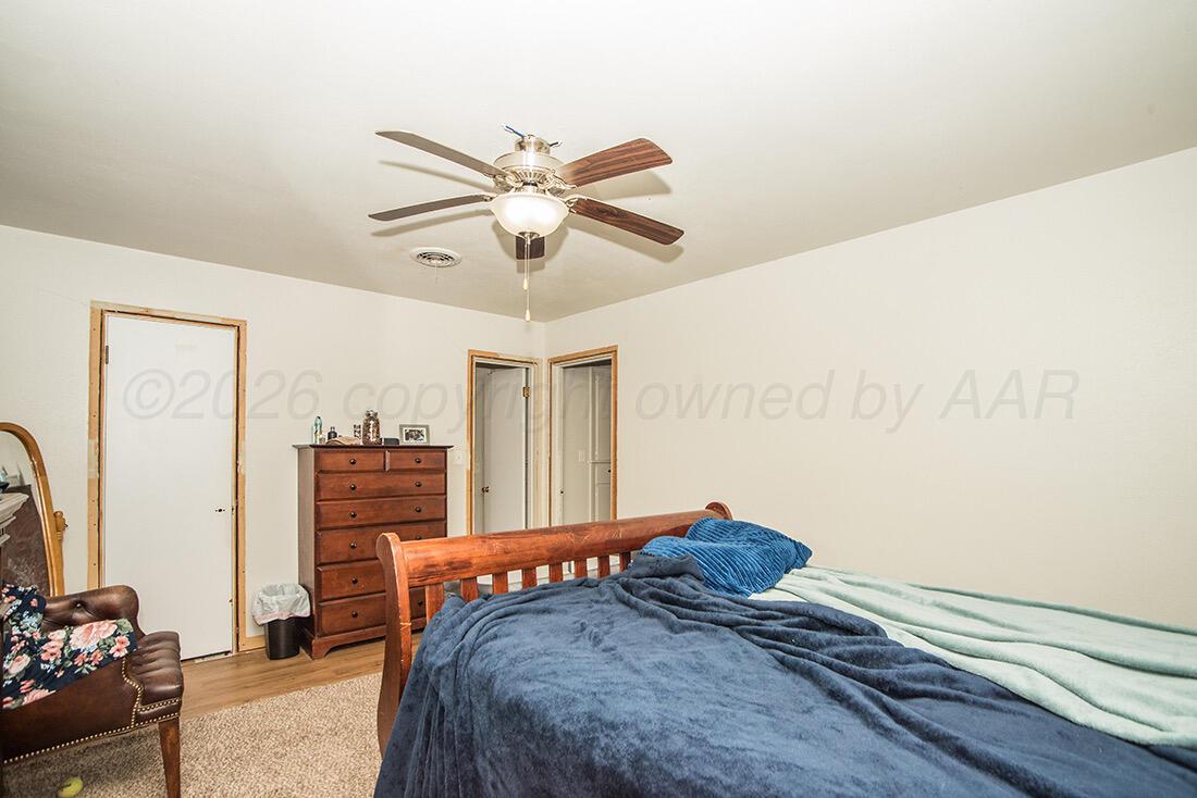 3609 Patterson Drive Amarillo, TX 79109 - Photo 15 of 21 a bedroom with a bed and a chandelier