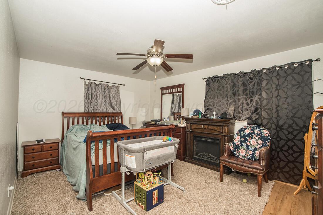 3609 Patterson Drive Amarillo, TX 79109 - Photo 17 of 21 a bedroom with furniture and a fireplace