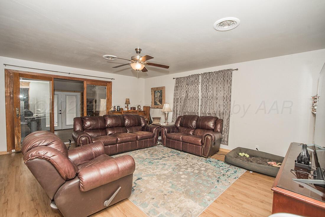 3609 Patterson Drive Amarillo, TX 79109 - Photo 6 of 21 a living room with furniture and a chandelier