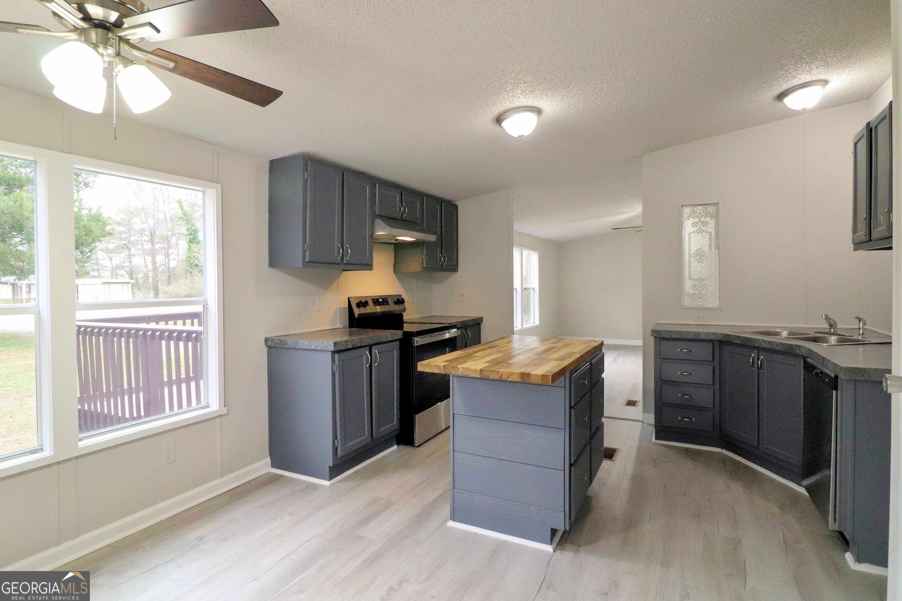 2200 Ridgeside Drive Villa Rica, GA 30180 - Photo 12 of 32 a kitchen with granite countertop a stove and a sink