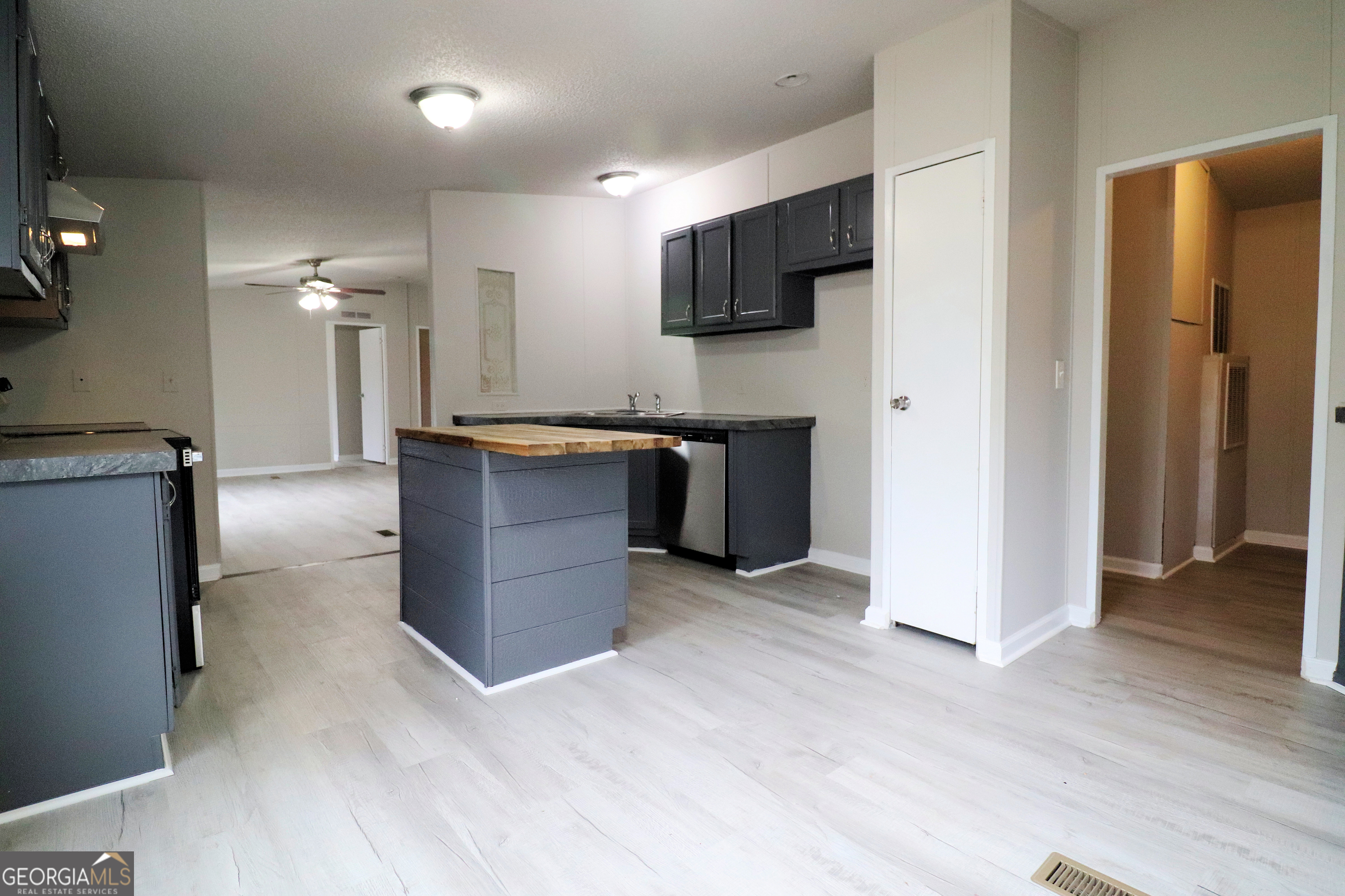 2200 Ridgeside Drive Villa Rica, GA 30180 - Photo 14 of 32 a kitchen with stainless steel appliances granite countertop a refrigerator and a stove top oven