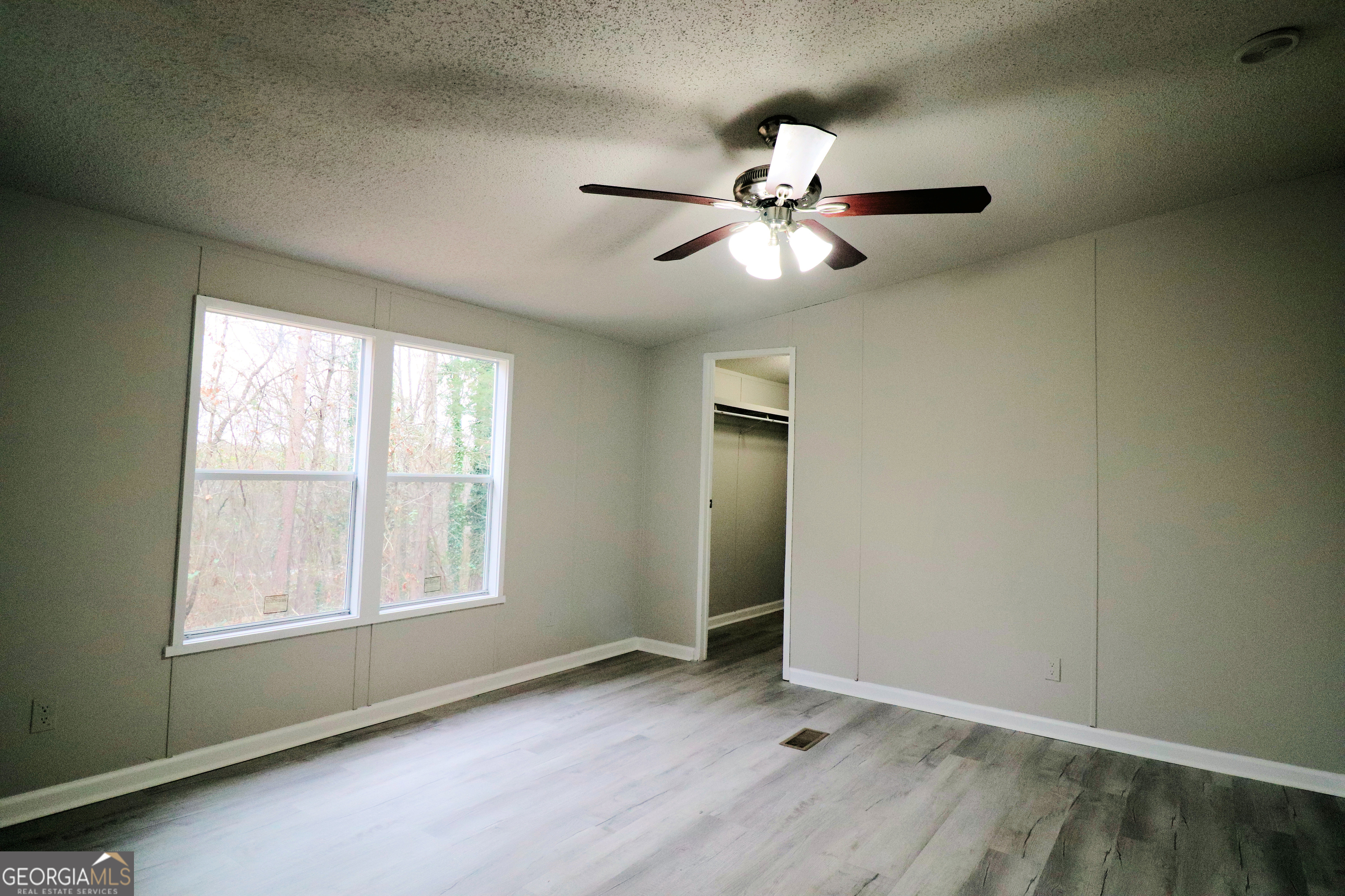 2200 Ridgeside Drive Villa Rica, GA 30180 - Photo 17 of 32 an empty room with windows and fan