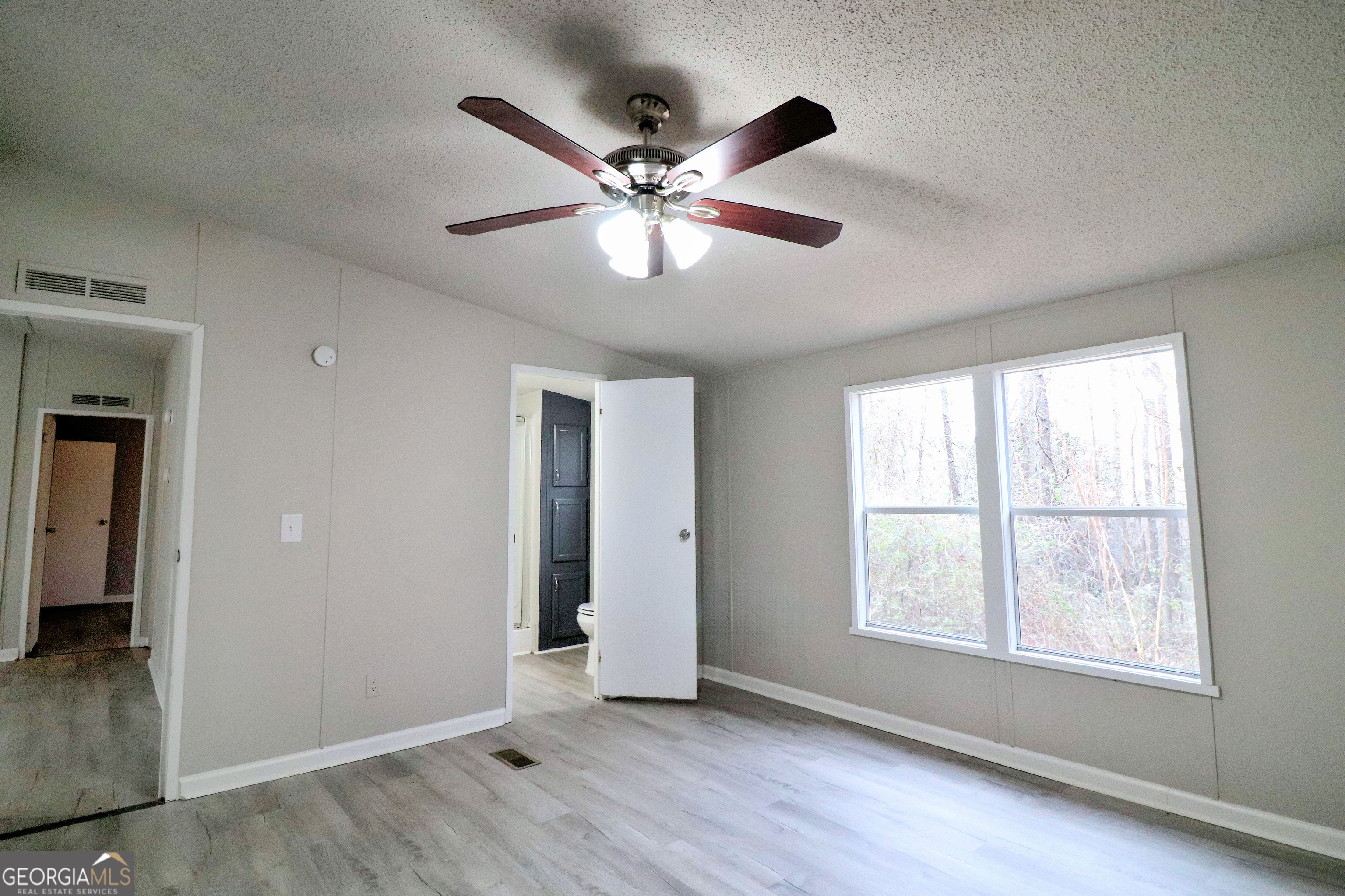 2200 Ridgeside Drive Villa Rica, GA 30180 - Photo 18 of 32 a view of an empty room with window and wooden floor