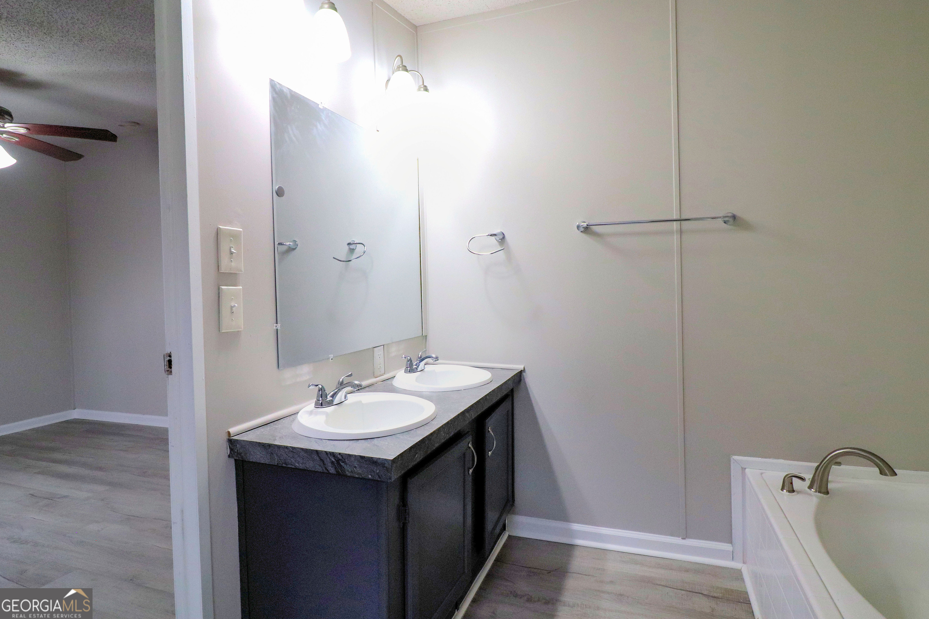 2200 Ridgeside Drive Villa Rica, GA 30180 - Photo 21 of 32 a bathroom with a sink and a mirror