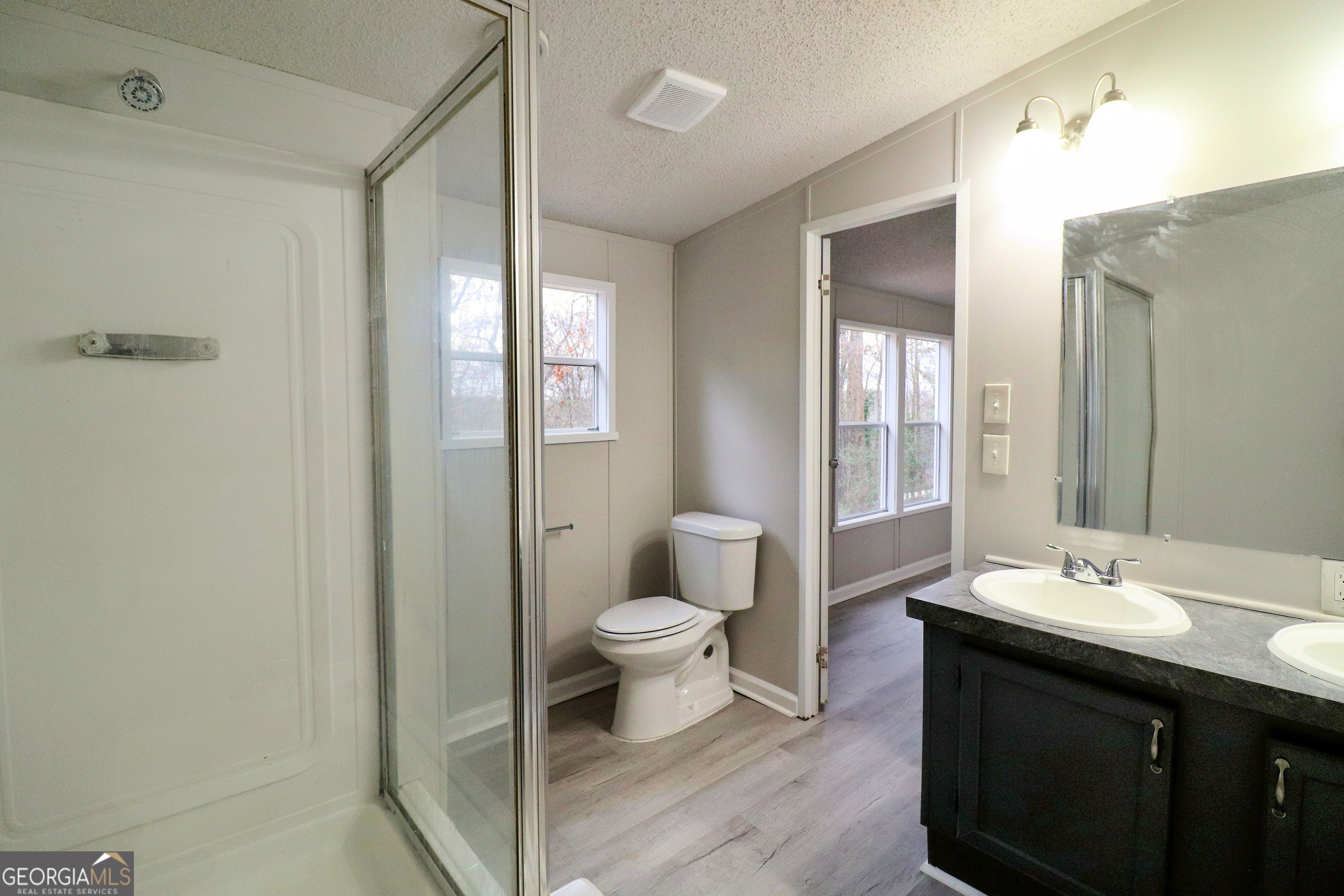 2200 Ridgeside Drive Villa Rica, GA 30180 - Photo 23 of 32 a bathroom with a double vanity sink toilet and shower