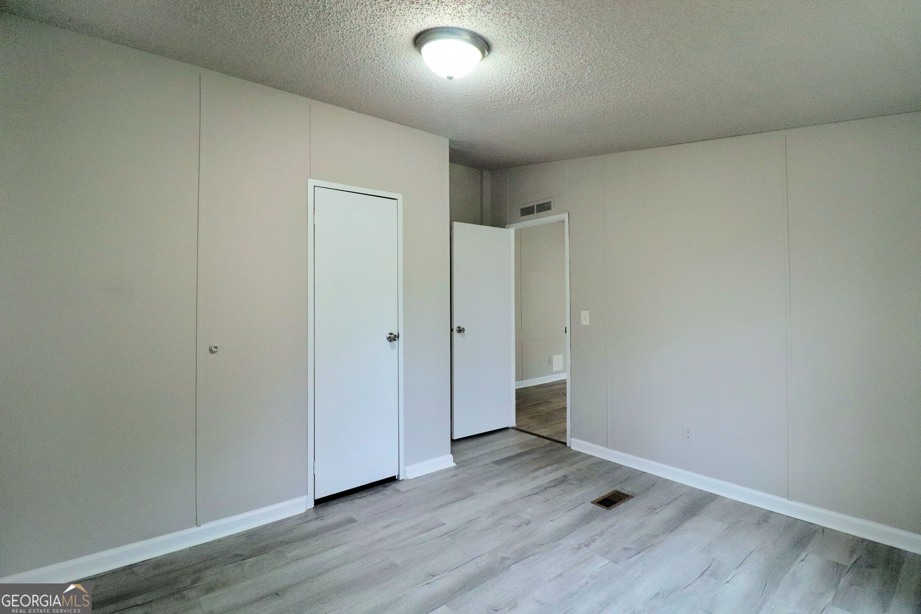 2200 Ridgeside Drive Villa Rica, GA 30180 - Photo 25 of 32 an empty room with wooden floor and windows