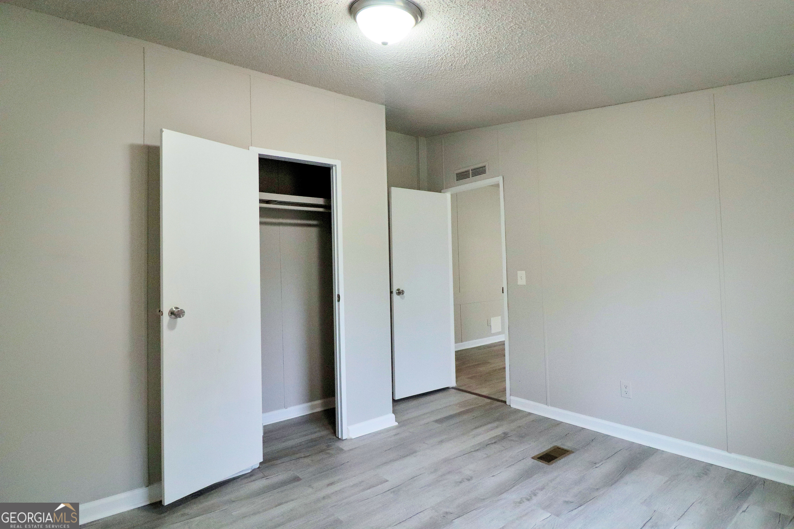 2200 Ridgeside Drive Villa Rica, GA 30180 - Photo 26 of 32 an empty room with wooden floor and closet
