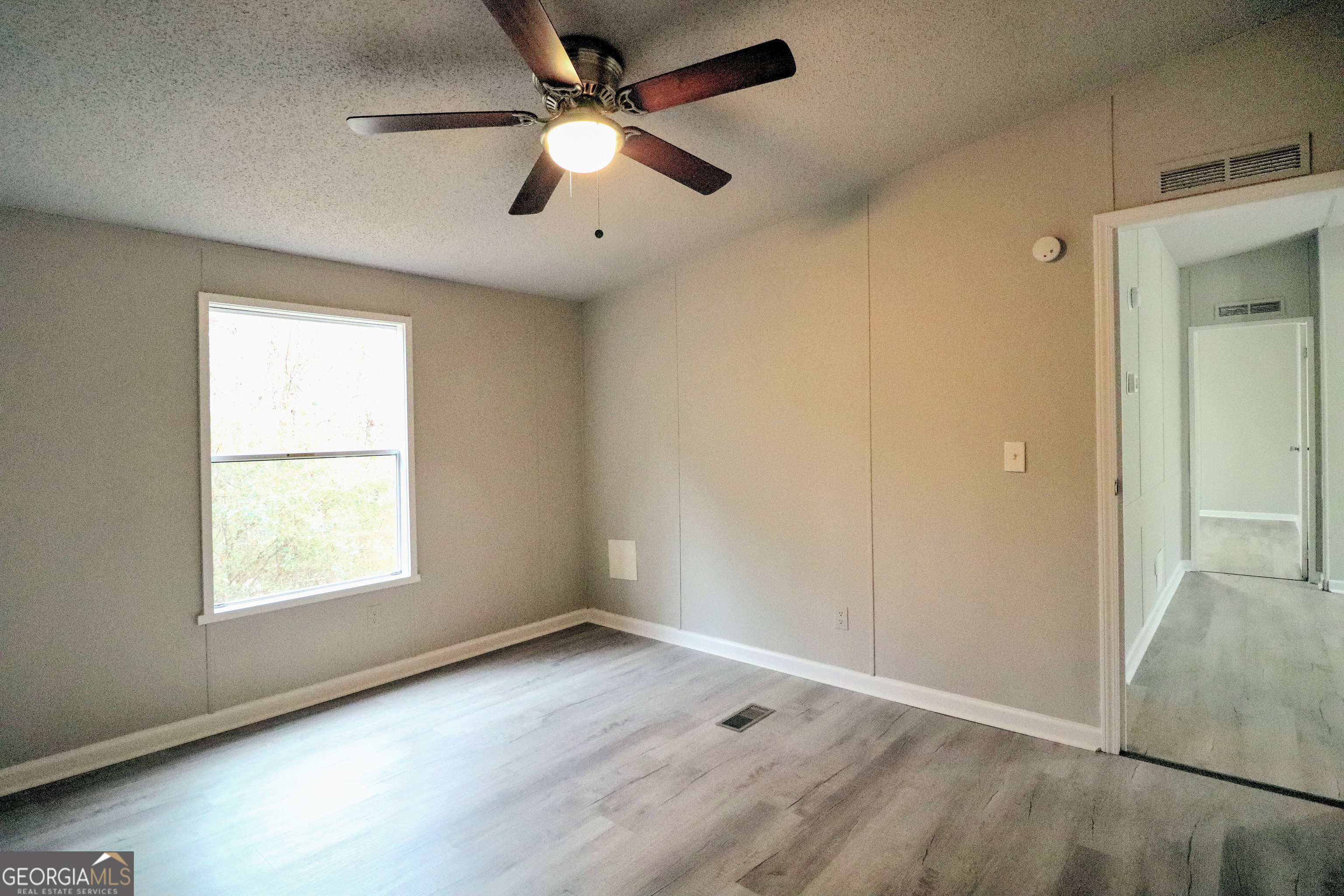2200 Ridgeside Drive Villa Rica, GA 30180 - Photo 29 of 32 an empty room with windows and fan