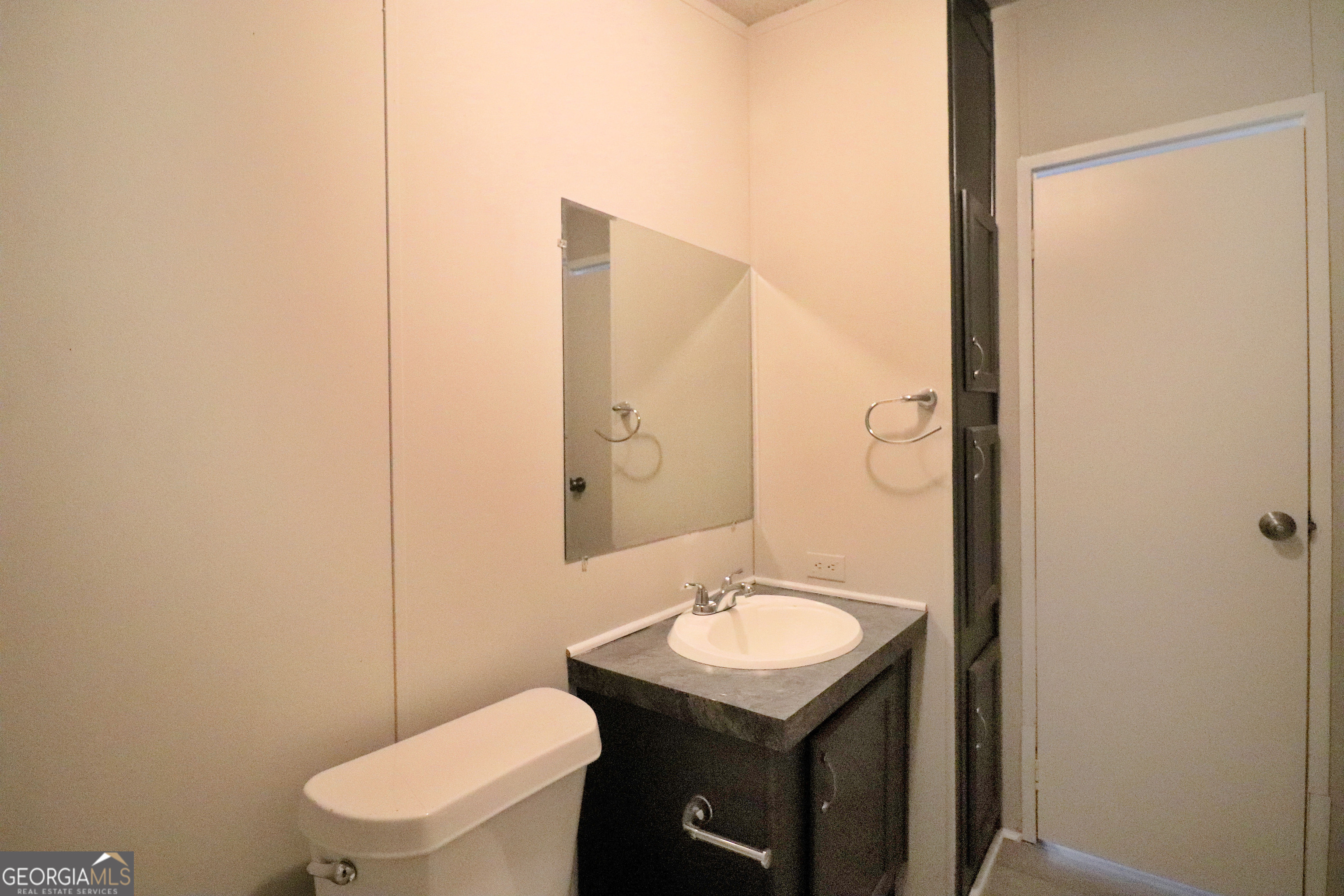 2200 Ridgeside Drive Villa Rica, GA 30180 - Photo 32 of 32 a bathroom with a sink a toilet a mirror and shower