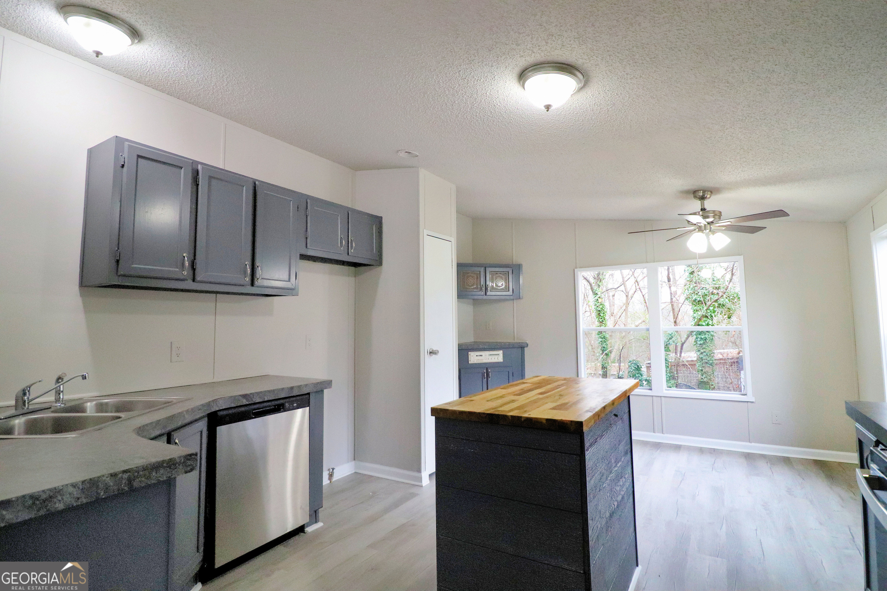 2200 Ridgeside Drive Villa Rica, GA 30180 - Photo 10 of 32 a kitchen with stainless steel appliances granite countertop a sink stove and refrigerator