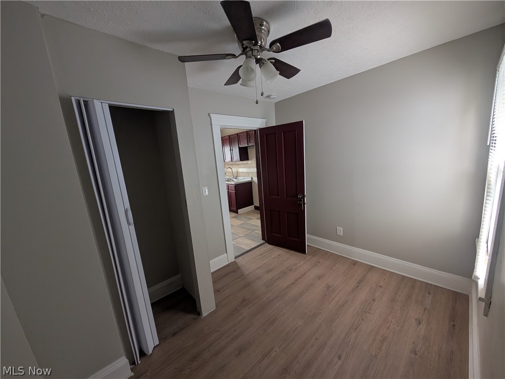 7515 Ottawa Road Cleveland, OH 44105 - Photo 14 of 21 Room featuring wood-finish flooring, light gray wall paint, and white baseboards