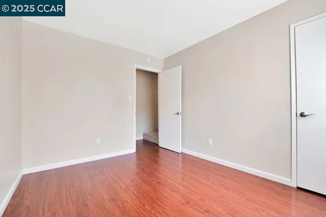 an empty room with wooden floor