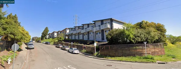 a view of a building with wooden fence