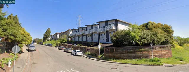 a view of a building with wooden fence