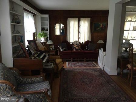 602 Brookwood Road Baltimore, MD 21229 - Photo 2 of 7 a living room with furniture and a floor to ceiling window