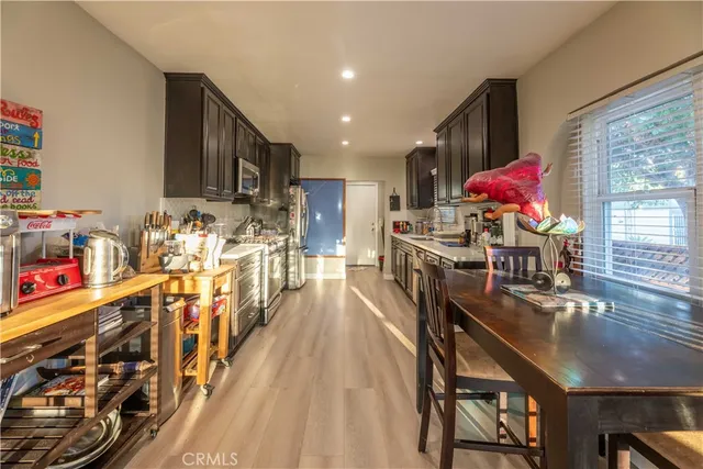 a dining room filled with furniture and wooden floor