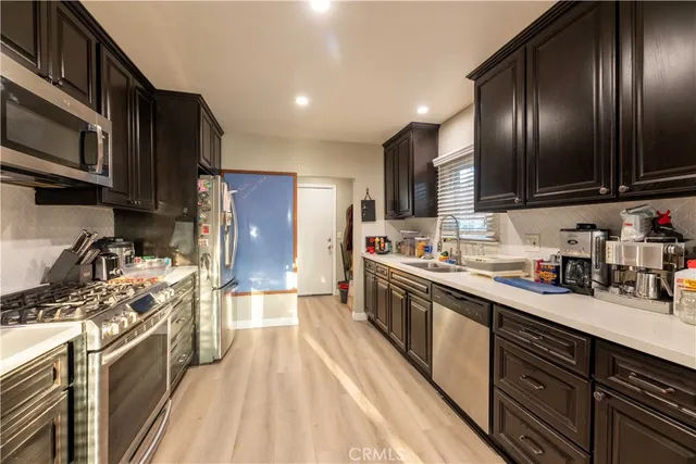 a kitchen with stainless steel appliances granite countertop lots of counter top space a sink and cabinets