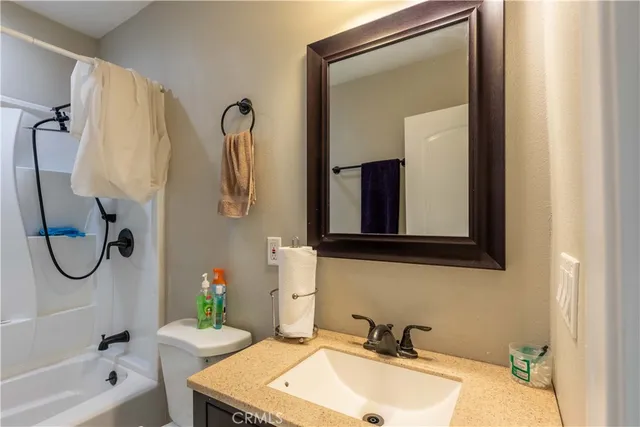 a bathroom with a tub sink and a mirror