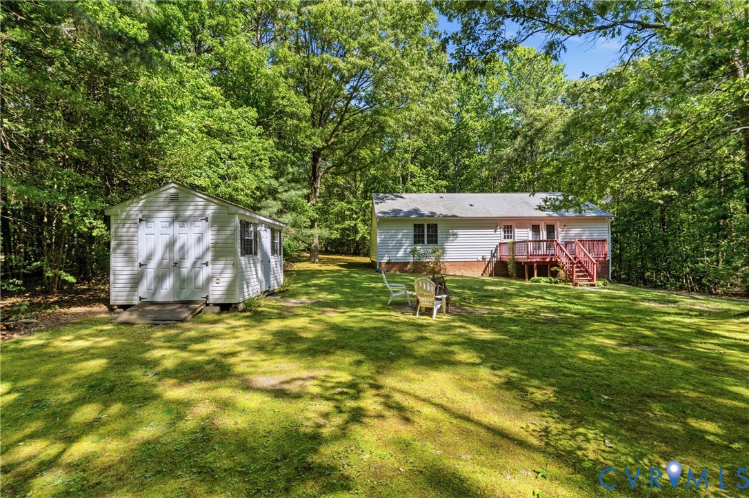 12654 Mt Olive Cohoke Road West Point, VA 23181 - Photo 31 of 31 a backyard of a house with table and chairs