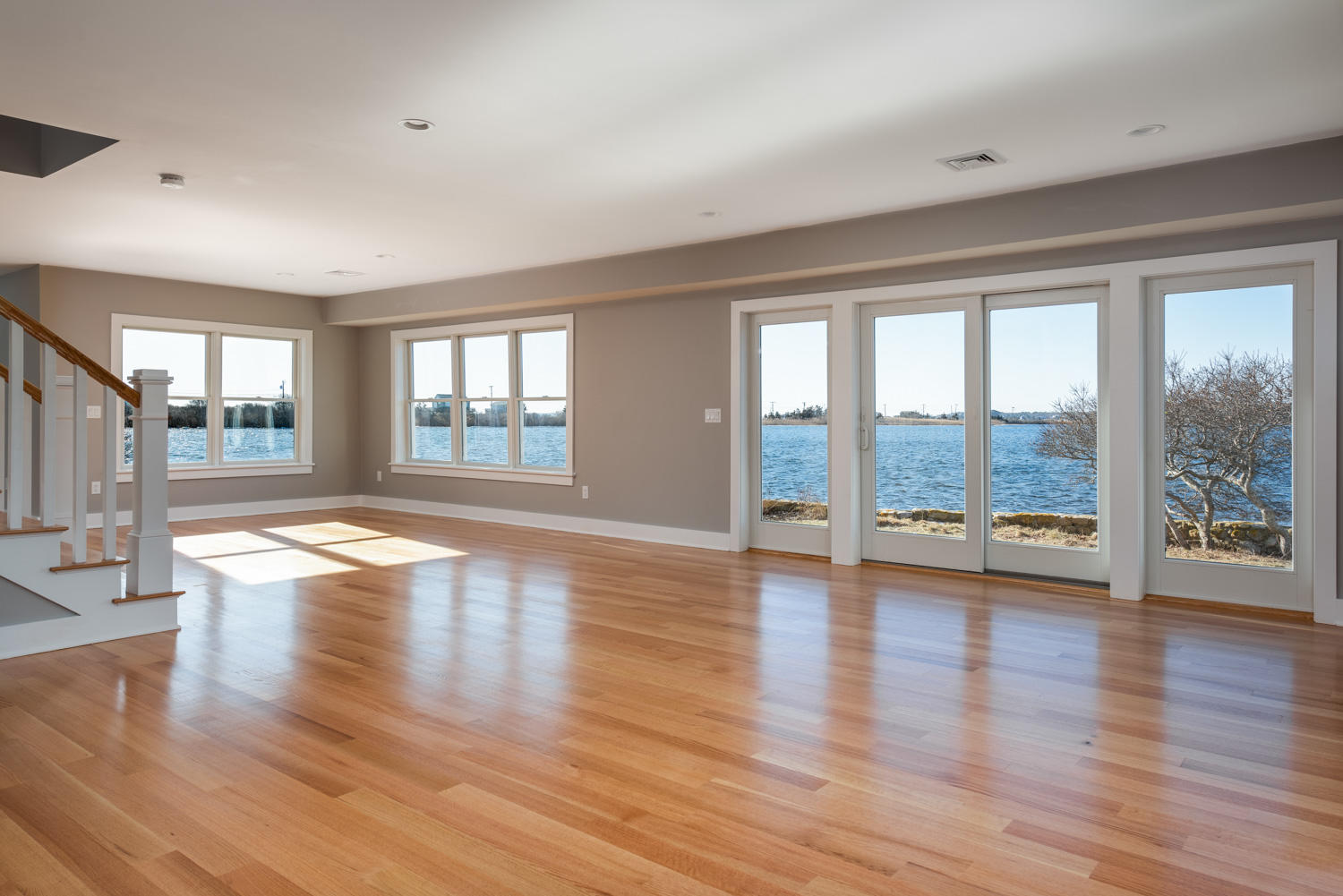 333 Mill Road Falmouth, MA 02540 - Photo 16 of 68 a view of empty room with wooden floor and floor to ceiling window