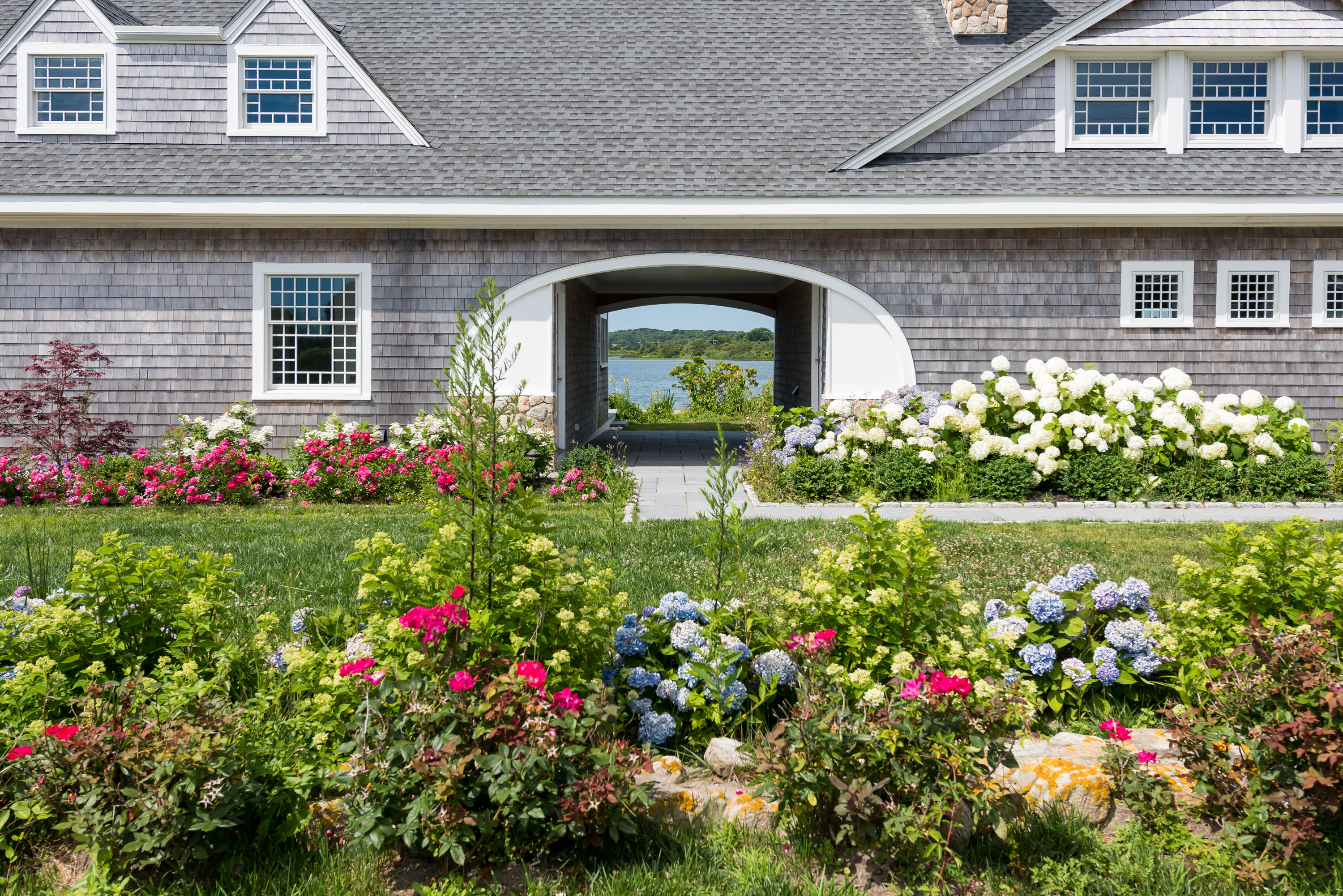 333 Mill Road Falmouth, MA 02540 - Photo 3 of 68 a front view of a house with a yard and flowers