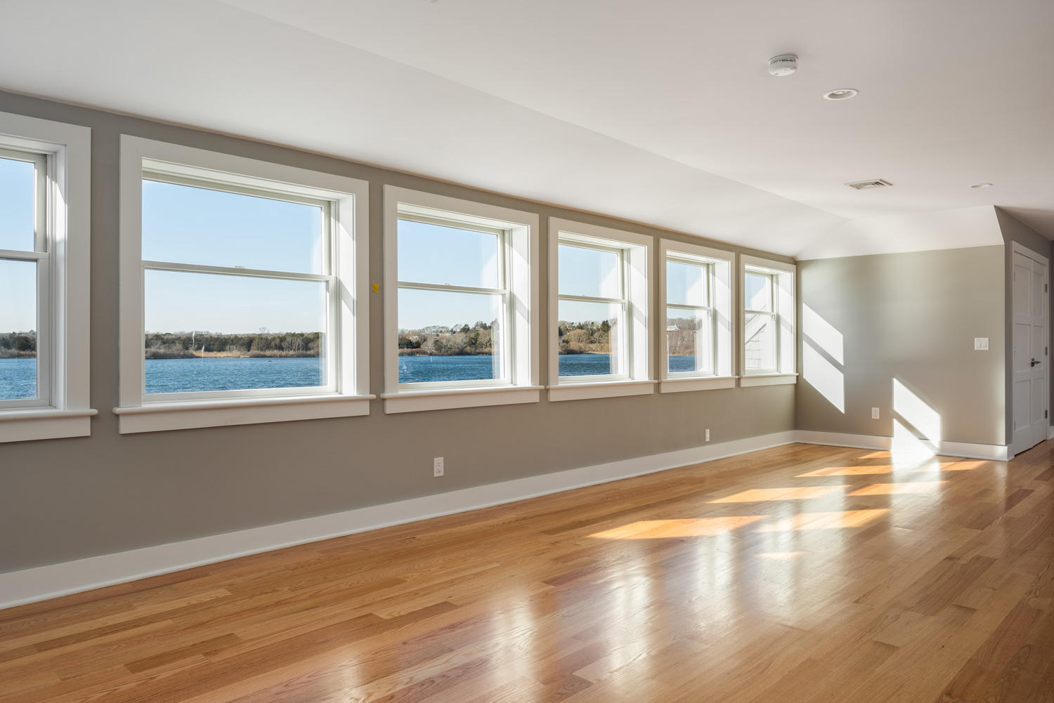 333 Mill Road Falmouth, MA 02540 - Photo 39 of 68 a view of empty room with wooden floor and fan