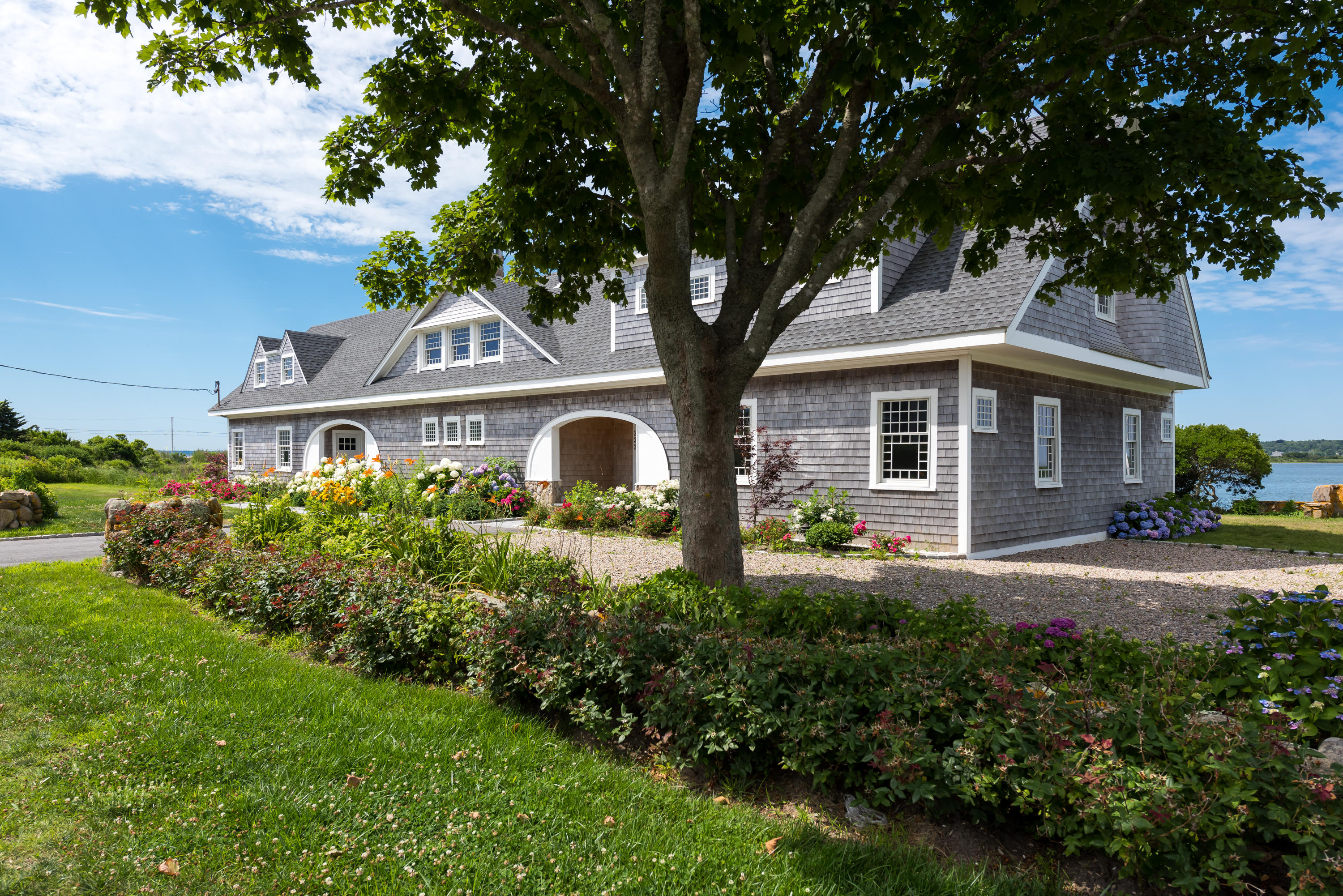 333 Mill Road Falmouth, MA 02540 - Photo 5 of 68 a front view of a house with a yard and garage