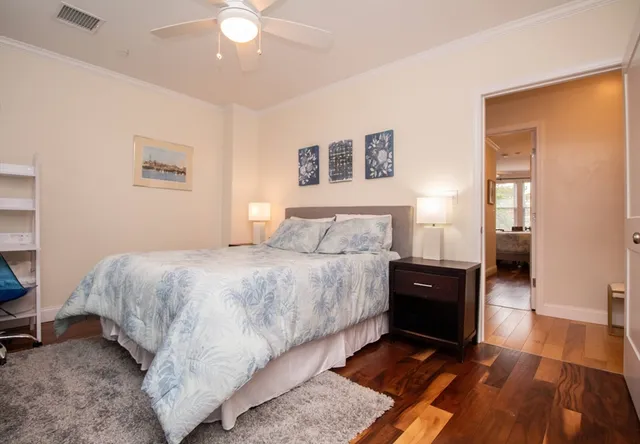 a bedroom with a bed and a chandelier