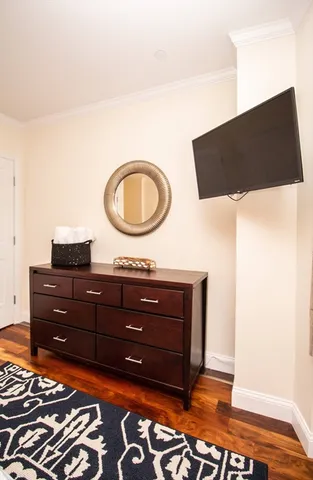 a living room with a bed and a mirror