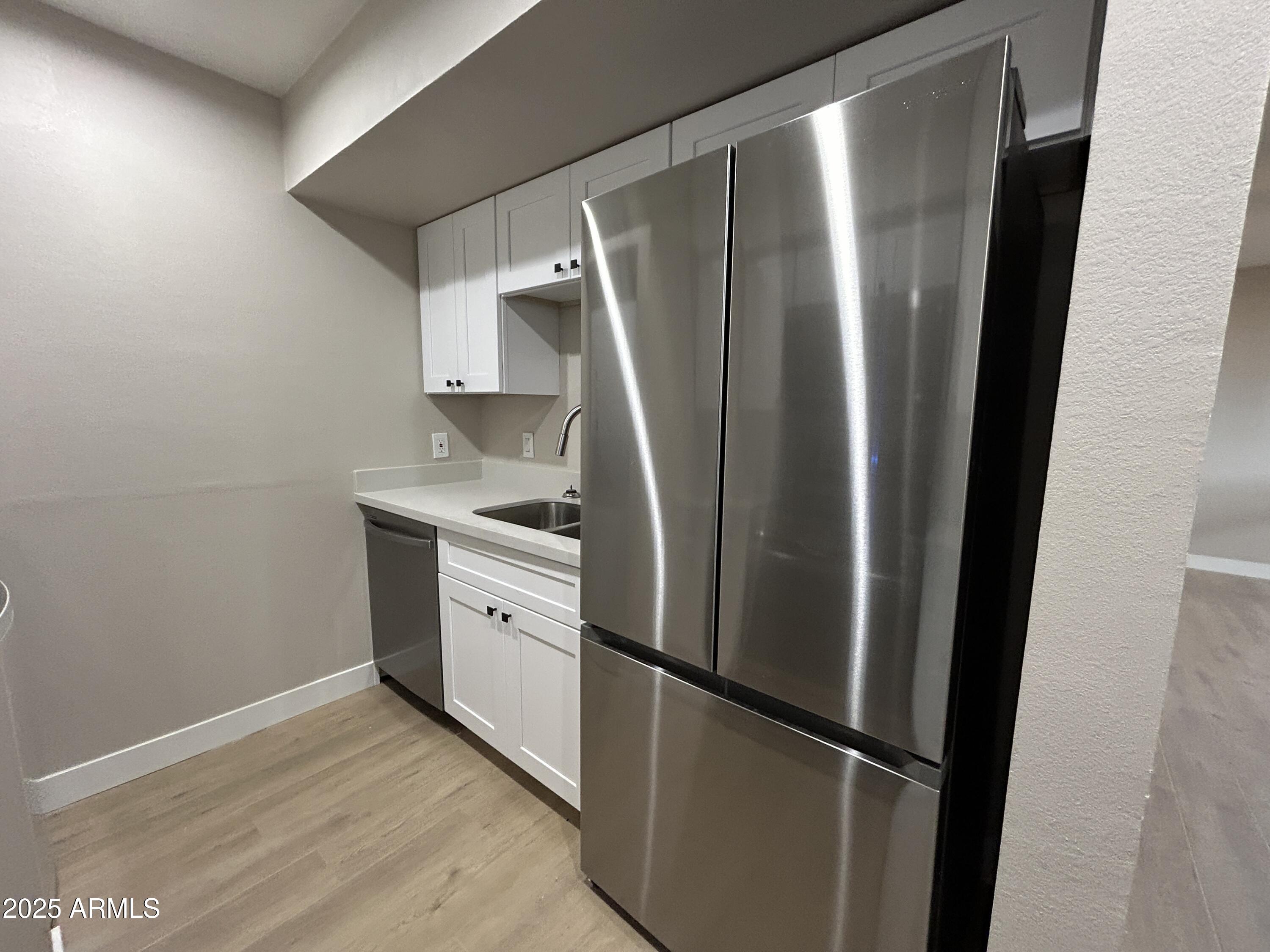 2699 East Silk Oak Drive Tempe, AZ 85288 - Photo 13 of 19 a kitchen with stainless steel appliances a refrigerator and a sink