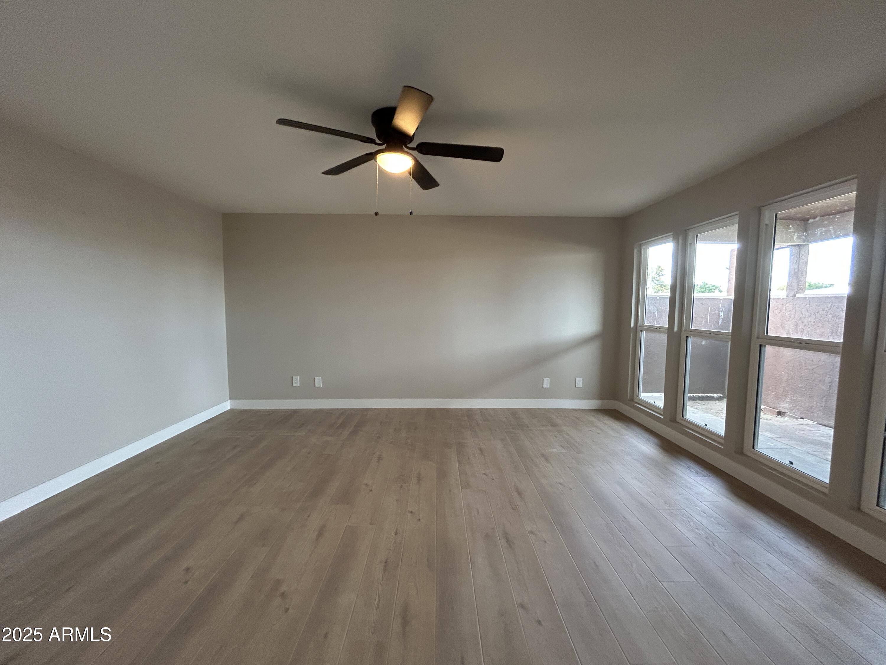 2699 East Silk Oak Drive Tempe, AZ 85288 - Photo 14 of 19 an empty room with wooden floor and windows