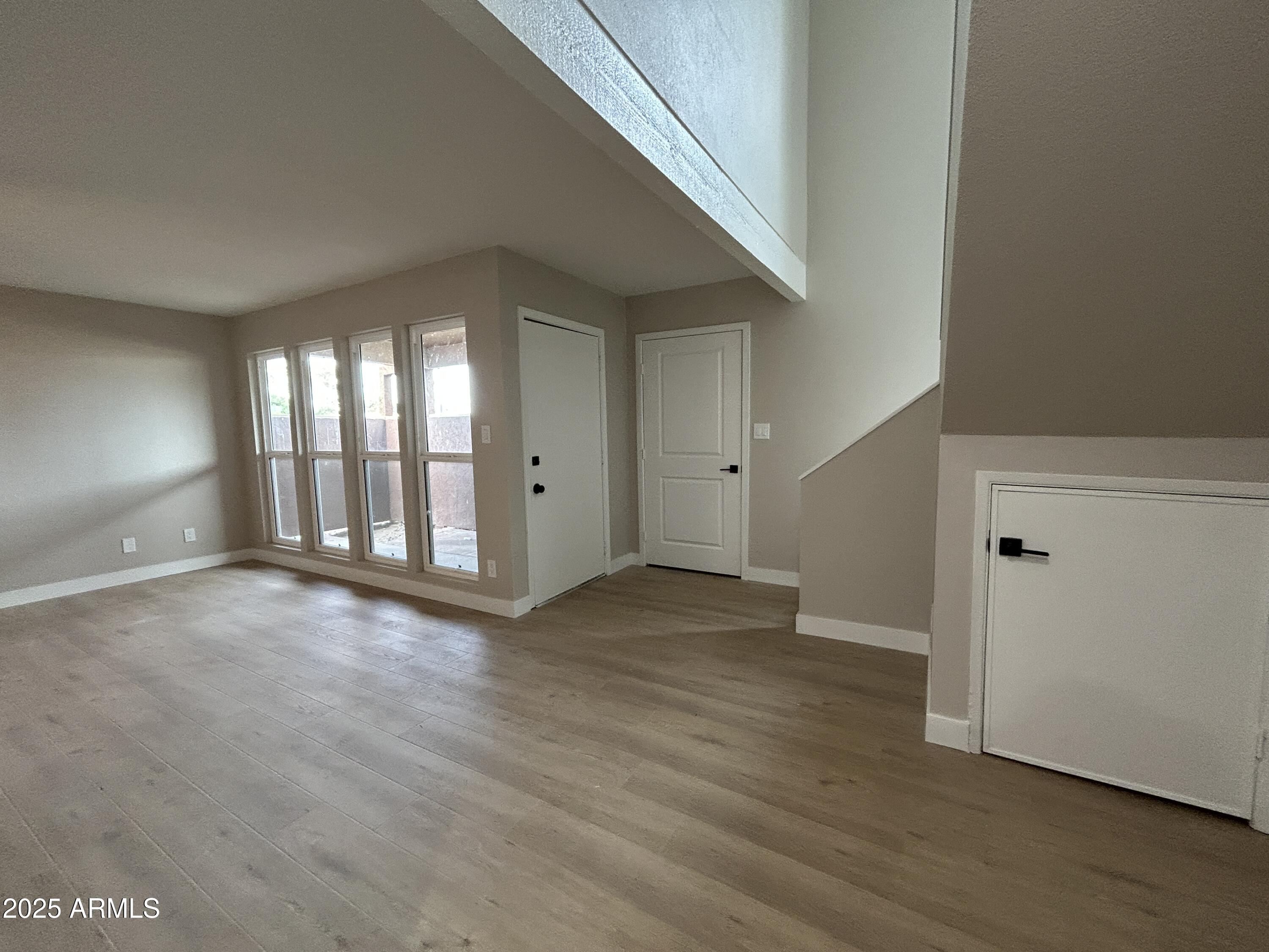 2699 East Silk Oak Drive Tempe, AZ 85288 - Photo 15 of 19 an empty room with wooden floor and windows
