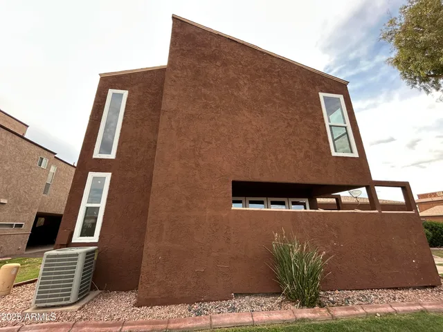 a backyard of a house with table and chairs