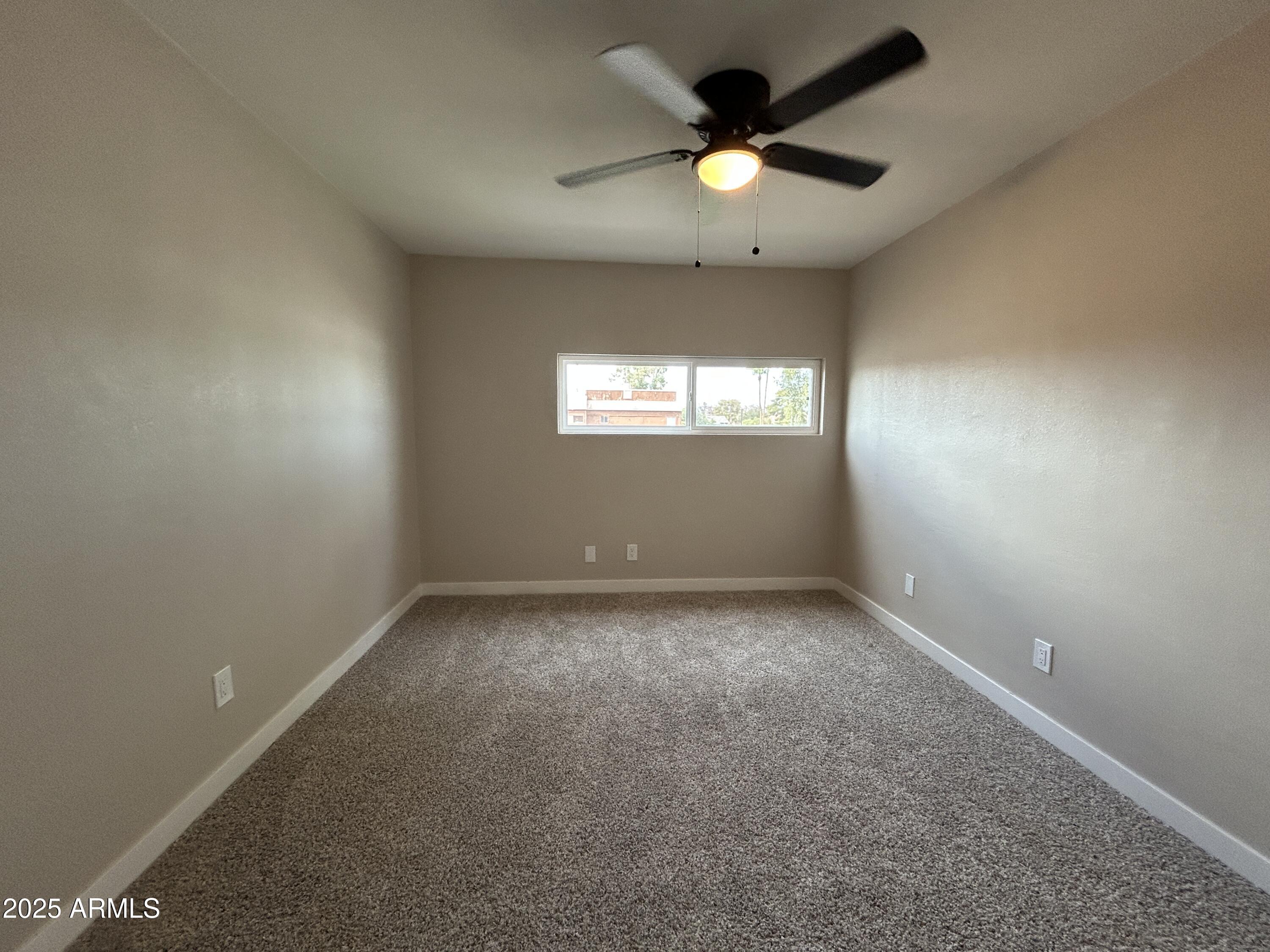 2699 East Silk Oak Drive Tempe, AZ 85288 - Photo 4 of 19 an empty room with a window