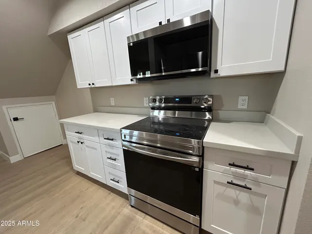 a white stove top oven sitting inside of a kitchen