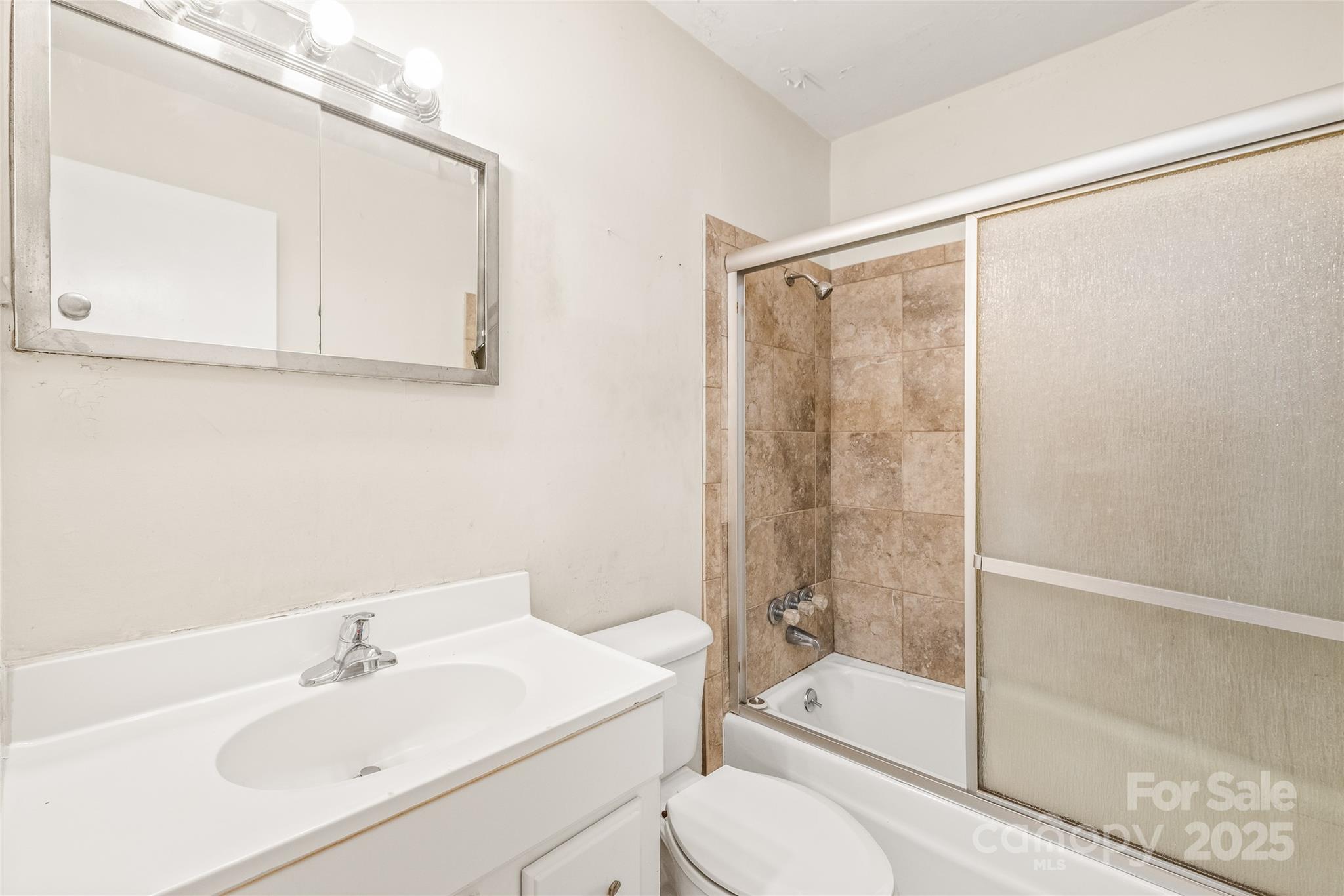 7207 Idlewild Road Charlotte, NC 28212 - Photo 11 of 15 a bathroom with a sink toilet and shower