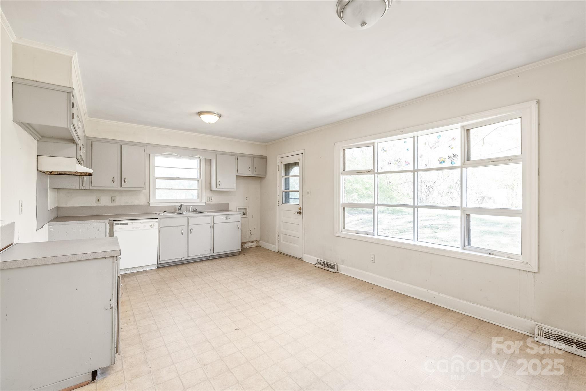 7207 Idlewild Road Charlotte, NC 28212 - Photo 5 of 15 a large white kitchen with a window